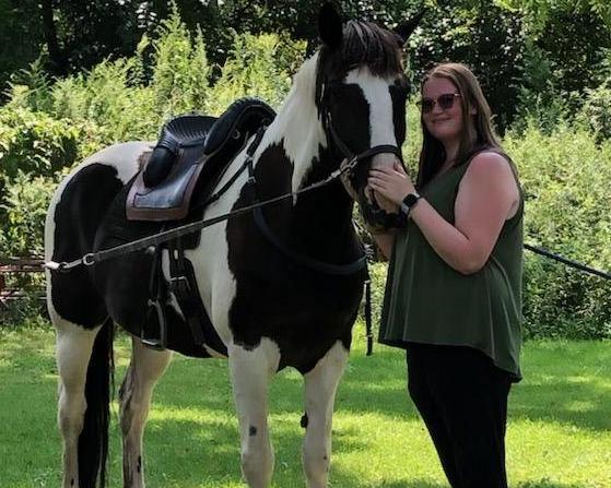 Alysa standing with her horse